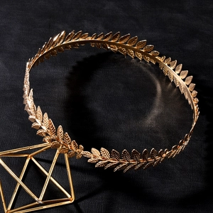 Elegant gold baroque laurel leaf crown tiara accessory on a premium black background