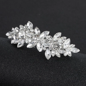 Macro detail of silver horse-eye crystal rhinestones in elegant floral hair clip design