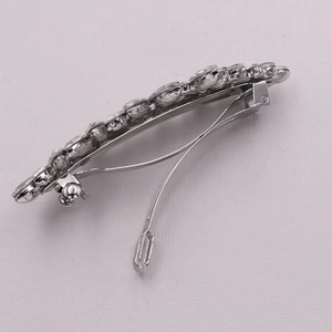 Elegant silver spring hair clip with shimmering white marquise rhinestones on lilac background
