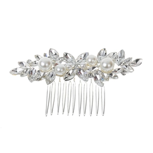 Close-up of bridal hair comb with marquise crystals and white pearls on silver base