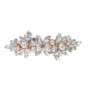 Detailed close-up of marquise glass rhinestones and white pearls on gold spring hair clip
