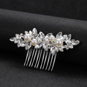 Detail of bridal hair comb featuring marquise crystals, white pearls, and silver base