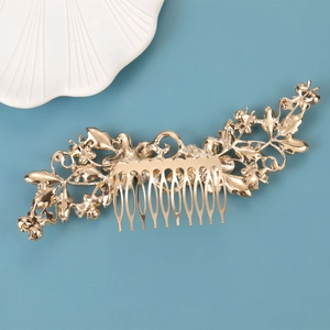 Detail of a 10-tooth gold bridal hair comb featuring intricate floral metal patterns