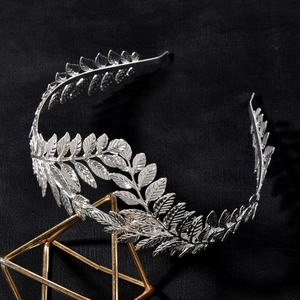 Detailed macro shot of silver baroque leaf crown with intricate metallic textures