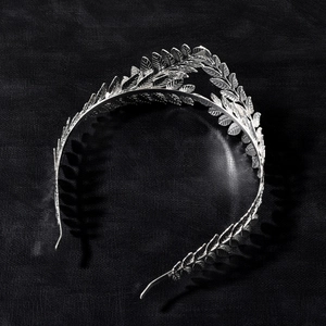 Detailed macro view of silver laurel leaf tiara with vintage metallic leaf texture
