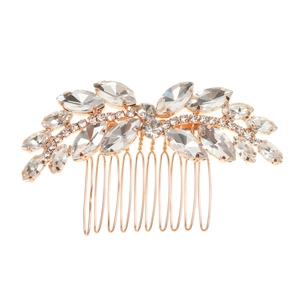 Close-up of golden bridal hair comb with elegant leaf patterns and sparkling rhinestones