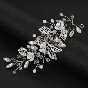 Elegant bridal hair vine with silver leaves, white flowers, and crystal pearls on a black stand