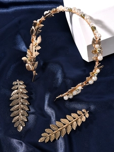 Detailed close-up of Baroque gold leaf bridal hairband set with pearls and crystals