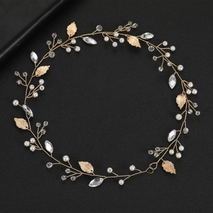 Macro detail of bridal gold leaf hair vine with white pearls and sparkling rhinestones