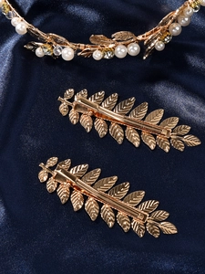 Detail of baroque gold leaf bridal hair accessories with pearls and crystals