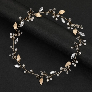 Golden bridal hair vine with metallic leaves, white pearls and sparkling crystals on black