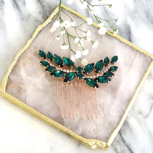 Macro detail of emerald green bridal hair comb with marquise crystals in rose gold finish