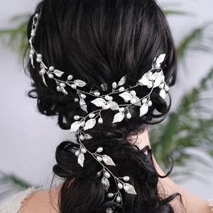 Silver bridal hair vine with white pearls and metal leaves for elegant wedding hairstyles