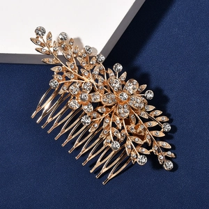 Detailed macro view of bridal hair comb featuring golden alloy leaves and sparkling crystals