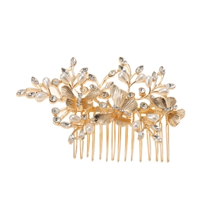 Detail of golden butterfly hair comb with sparkling rhinestones and elegant pearls