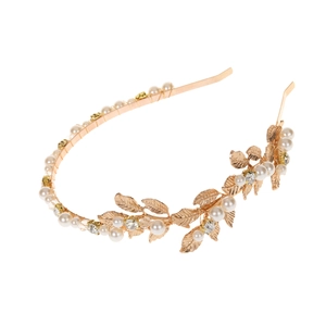 Golden Baroque leaf bridal headband with pearls and rhinestones on a white background