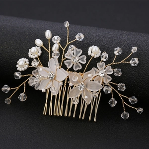 Detail of handmade gold wire bridal hair comb with pearls, crystals and frosted flowers