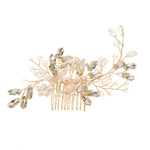 Exquisite gold bridal hair comb with white pearls and sparkling crystal beads on white background