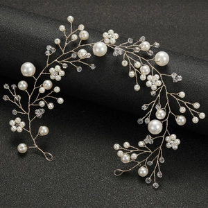 Detailed macro view of golden wire bridal hair vine with white pearls and crystals