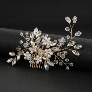 Detailed close-up of a handmade bridal hair comb with gold wire, pearls and crystals
