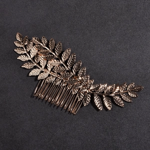 Elegant rose gold metal hair comb featuring detailed triple leaf design for bridal wedding hair