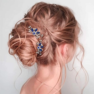 Close-up of blue marquise crystal and pearl hair pins styled in an elegant updo