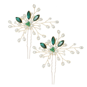 Detail of bridal hair pins with green marquise gems, white pearls, and gold wiring