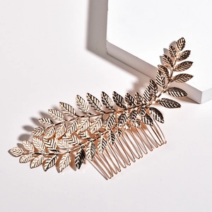 Golden leaf hair comb accessory with intricate vein texture for elegant bridal wedding hair