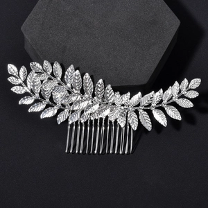 Macro detail of silver leaf bridal hair comb showing delicate textures and polished finish