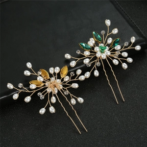 Detail of bridal hair pins set with blue marquise rhinestones and pearls on gold wire