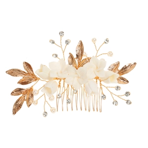 Elegant bridal hair comb with white ceramic flowers, gold leaves, and crystals
