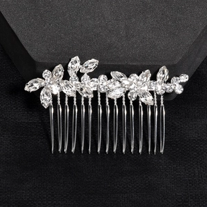 Elegant silver bridal hair comb with floral rhinestones and crystals on a dark base