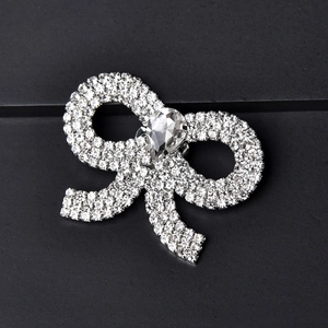 Elegant silver bow shoe clips with shimmering crystals and a pear-cut centerpiece drop