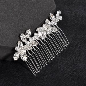 Detailed macro view of silver bridal hair comb with sparkling leaf-shaped rhinestones