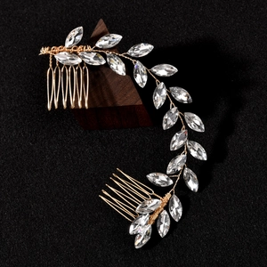 Exquisite bridal hair vine comb with marquise crystals and golden wire on black velvet