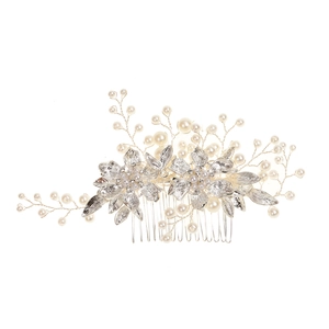 Detailed view of silver bridal hair comb with handmade metal flowers and white pearls
