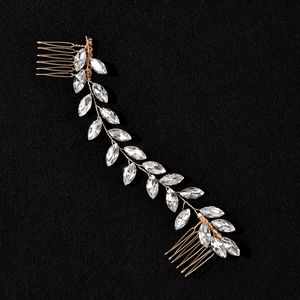 Detailed macro shot of bridal hair comb featuring golden wire and marquise crystals