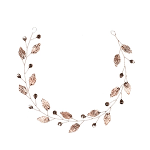 Detailed macro view of handmade rose gold leaf bridal hair vine with crystal beads