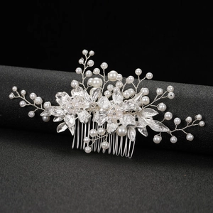 Elegant silver wedding hair comb with white pearls and sparkling crystals on black display
