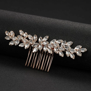 Rose gold bridal hair comb with marquise crystal leaves on a black textured background