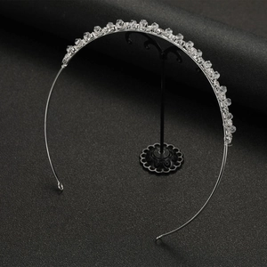 Close-up of silver wire bridal headband with clear multi-faceted crystals on a display