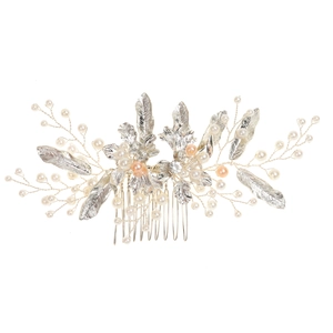 Detailed macro of handmade bridal hair comb with silver alloy leaves and pearls
