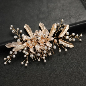 Elegant gold bridal hair comb with pearls and leaf patterns for wedding hairstyles