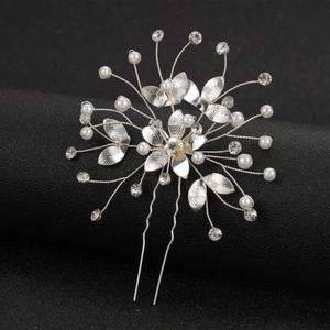 Silver flower bridal hair pin with pearls and rhinestones on a black background