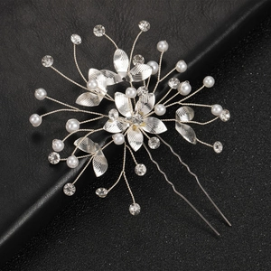 Silver flower bridal hair pin with pearls and rhinestones on black leather background