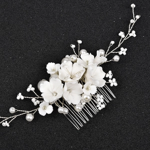 Détail du peigne à cheveux de mariée fait main avec fleurs blanches et perles nacrées