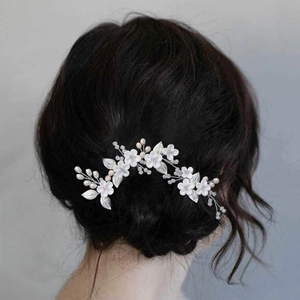Elegant bridal hair pins set with white clay flowers and silver metallic leaves