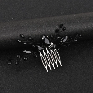 Detailed view of bridal hair comb with black teardrop crystals on a metallic base