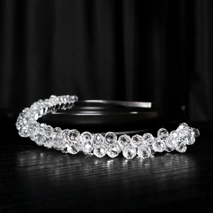 Macro shot of silver crystal beaded bridal headband with transparent multifaceted beads