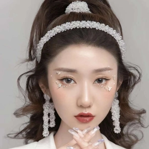 Detailed close-up of bridal crystal beaded headband and matching tassel earring set